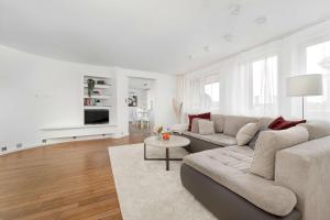 a white living room with a couch and a table at Family Apartment with 3 Bedrooms & Air Conditioning in the Centre of Wrocław by Noclegi Renters in Wrocław +29 photos