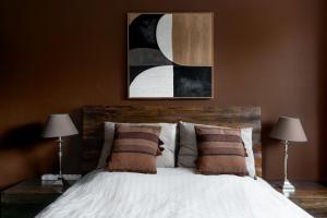 a bedroom with a large bed with two lamps at Baltic Breeze Lodge in Gdynia +30 photos