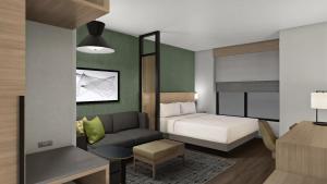 a hotel room with a bed and a couch at Hyatt Place Guyana Georgetown in Georgetown