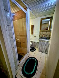 a bathroom with a shower and a sink and a mirror at Shengeza Lake Lodge in KuShengesa