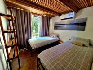a small room with two beds and a window at Shengeza Lake Lodge in KuShengesa