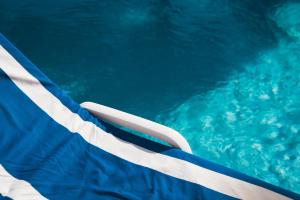 an image of a swimming pool with an american flag at Auberge du Rédier - Logis Hôtels in Colomars