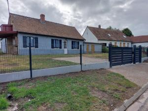 a house with a fence in front of a house at Les jonquilles in Forest-Montiers