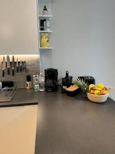 a kitchen with a bowl of fruit on a counter at Le Lido - Piscine, proche plage in Cros-de-Cagnes