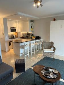 a kitchen and a living room with a table at Le Lido - Piscine, proche plage in Cros-de-Cagnes +15 photos