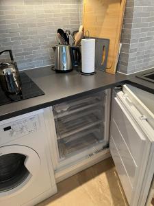 a kitchen with a counter with a stove and a microwave at Le Lido - Piscine, proche plage in Cros-de-Cagnes
