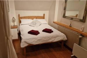 a bedroom with a bed with two towels on it at 3 Bed Cottage Sleeps 6 - Enclosed Patio -Fireplace in Beaucoudray