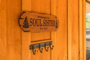a welcome to south sister sign on a wooden door at WiFi & Waterfront - Soul Sister Red River Gorge KY in Rogers