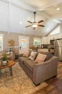 a living room with a couch and a ceiling fan at WiFi & Waterfront - Soul Sister Red River Gorge KY in Rogers