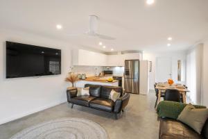 a living room with a couch and a table at Chrissie's Cottage in Dunsborough
