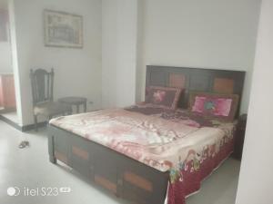 a bedroom with a large bed with pink pillows at Murree top hotel in Murree