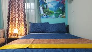 a bedroom with a bed with a painting on the wall at Bayview Luxury Retreats in Montego Bay