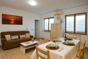 a living room with a table and a couch at Villa Asia Deluxe in Castiglione del Lago
