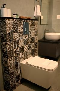 a bathroom with a toilet and a sink at The village vista in Batheri