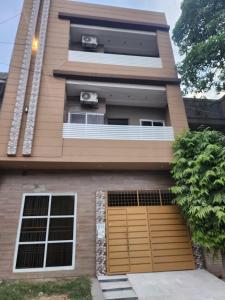 a house with a brown door at Guest House & Apartments Johar Town near Emporium & Expo in Lahore
