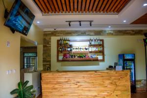 a bar with a wooden counter in a room at RP Gorilla Guest & Coffee in Taba