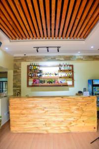 a store with a wooden counter in a room at RP Gorilla Guest & Coffee in Taba