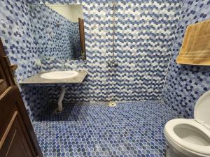 a blue and white bathroom with a sink and a toilet at Guest House & Apartments Johar Town near Emporium & Expo in Lahore +19 photos