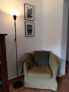 a living room with a couch and a lamp at Casa del Medico in Olmeda de las Fuentes