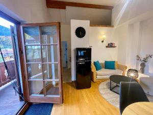 a living room with a glass refrigerator and a couch at Ferienwohnung Mangfall - Berge, Natur und Ruhe in Hausham