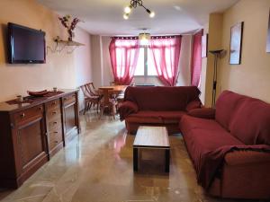 a living room with a couch and a table at HOUSE ATARFE II MOTRIL in Atarfe