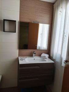 a bathroom with a sink and a mirror at HOUSE ATARFE II MOTRIL in Atarfe +73 photos