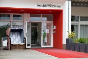 an entrance to a hospital with a red door at Schneeeule 209 in Granzow