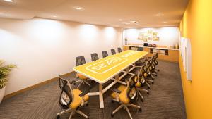 a conference room with a table and chairs at Bloom Hotel - M Block GK2 in New Delhi