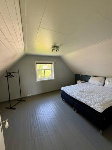 a bedroom with a large bed in a attic at Peaceful retreat in Lofoten in Sennesvik