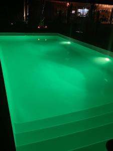 a pool table with green lights on it at Ranchos de la Tata in Las Calles +16 photos