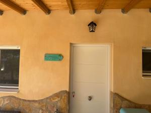 a door to a house with a sign on the wall at Las Atalayas Yecla in Yecla