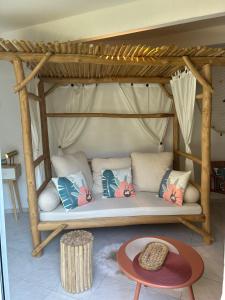 a bed with pillows and a table in a room at Esprit CAP FERRET in Puget