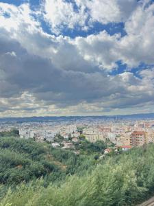 a view of a city under a cloudy sky at Up in Tirana Apartment in Tirana