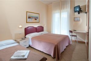 Postel nebo postele na pokoji v ubytování Hotel Souvenir