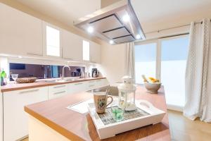 a kitchen with white cabinets and a counter top at Ferienhaus Auf der Ostsee in Kappeln