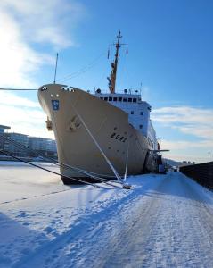 a large ship is docked on a snow covered road at Laivahostel S/S Bore in Turku