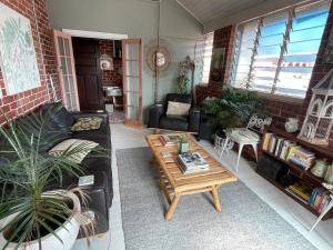 a living room with a couch and a coffee table at Women Only Guesthouse in Mullumbimby