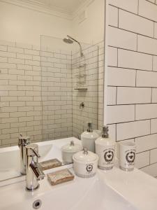 a white bathroom with a sink and two toilets at Women Only Guesthouse in Mullumbimby +49 photos