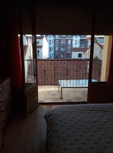 a bedroom with a bed and a view of a balcony at Chambre Luxurieux Gris in Perpignan