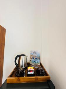 a coffee table with a tea kettle and other items on it at Ulu Khandra Homestay in Bingin Beach