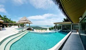 a pool at a resort with a view at Villanirvanasamui 