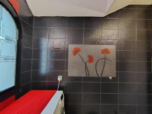 a bathroom with a painting of flowers on the wall at Katata Apartment Spacious House Floor with Terraces, 3 Bedrooms, Parking,Wi-Fi in Podgorica +25 photos
