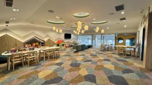 a lobby with a cafeteria with tables and chairs at Hotel Europa Fit Hévíz in Hévíz +58 photos