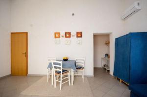 a dining room with a blue table and chairs at Apartments Nina in Stinica +15 photos
