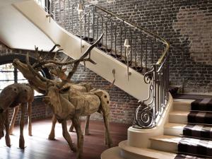a statue of a reindeer next to a staircase at Hôtel Le Royal Monceau Raffles Paris in Paris