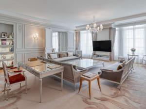 a living room with a couch and a table at Hôtel Le Royal Monceau Raffles Paris in Paris