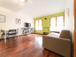 a living room with a couch and a table at Corso San Gottardo - Darsena Flat in Milan