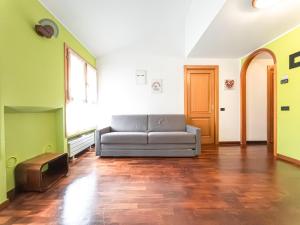 a living room with a couch in a room with green walls at Corso San Gottardo - Darsena Flat in Milan +20 photos