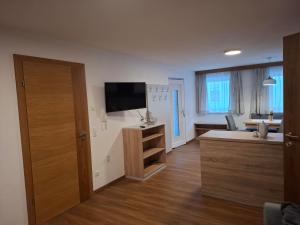 a living room with a flat screen tv on the wall at WG Appartment in Kleinarl