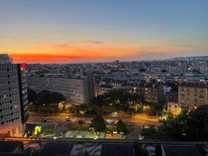 a view of a city at night with a sunset at Le Gémeaux - Paris - La Défense vue d'exception in Courbevoie